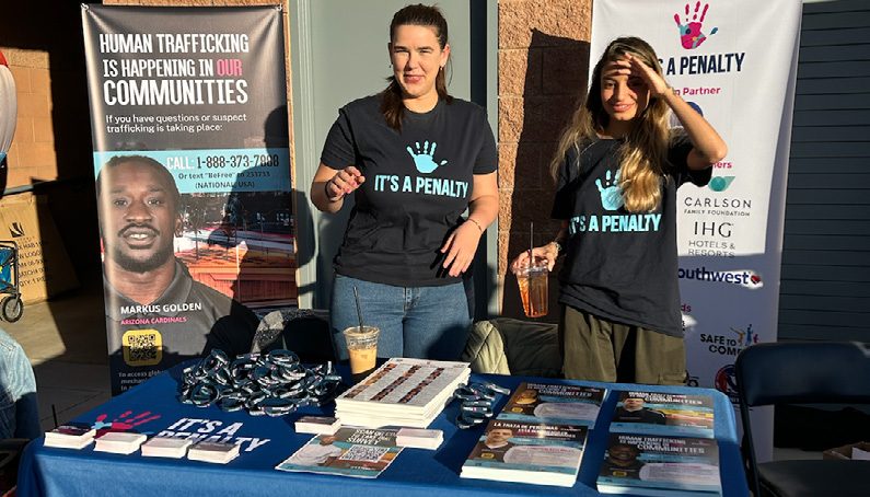 Event booth with campaign banners and branded T-shirts